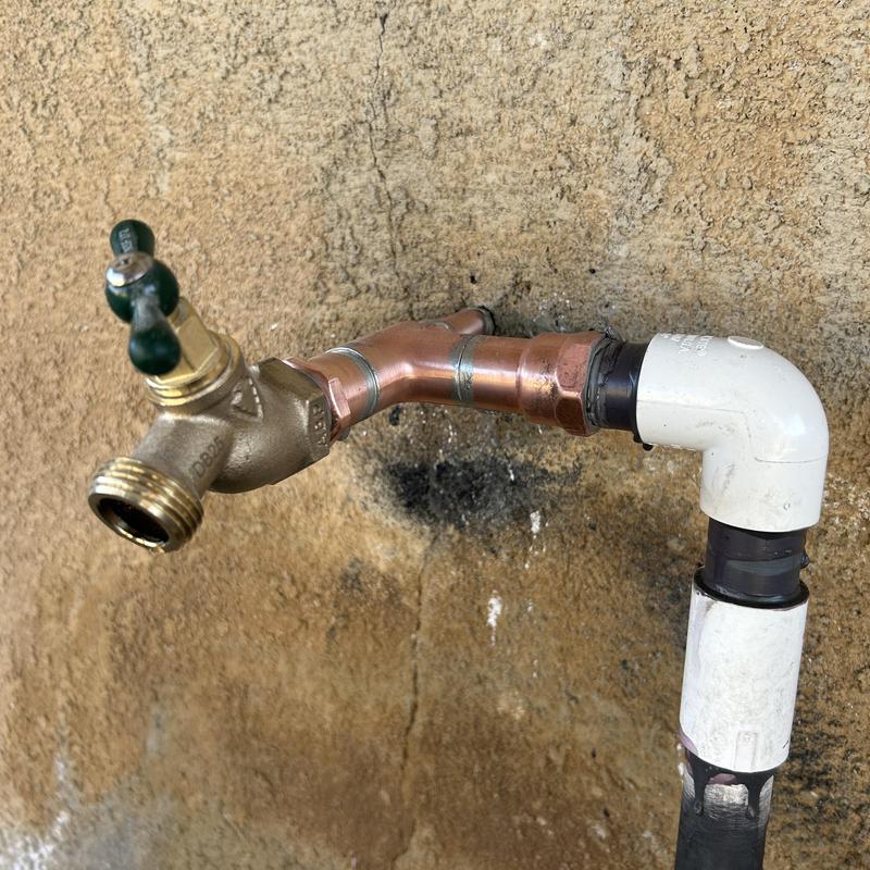 Hose bibb faucet with copper and PVC piping installed