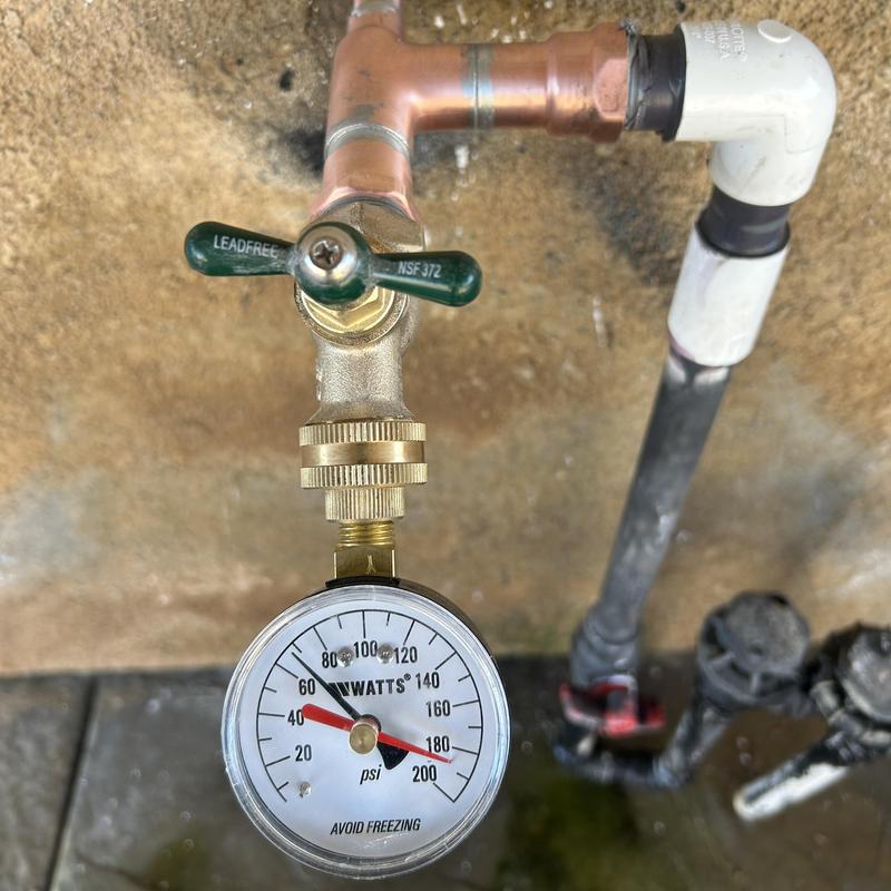 PVC and copper pipe with pressure gauge and faucet