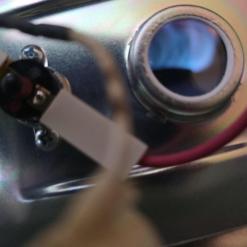 Water heater pilot light burning blue flame close-up