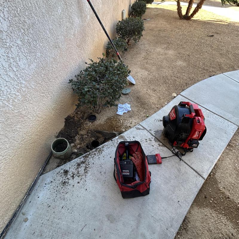 Sewer cleanout with plumbing tools and equipment outdoors