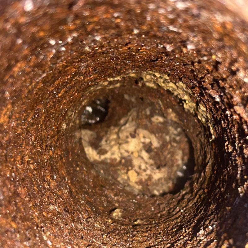 Cast-iron drain pipe clogged with toilet paper buildup