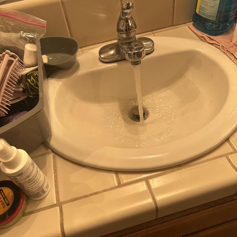 Bathroom sink faucet running with water flow