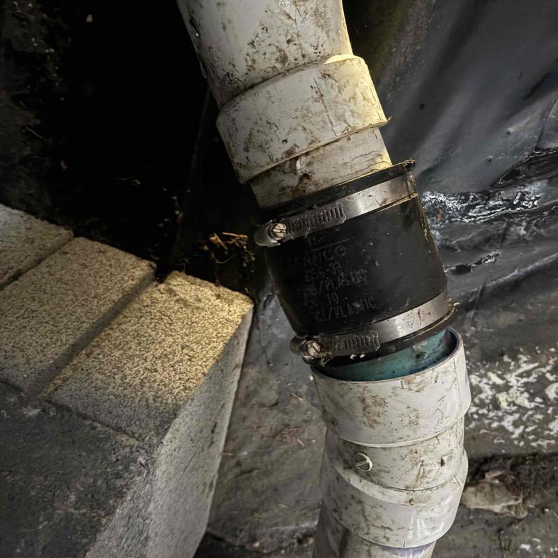 Main sewer line flexible coupling in crawlspace