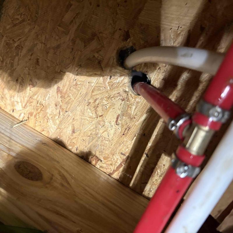 Hot side waterline tee with clamps under wood floor
