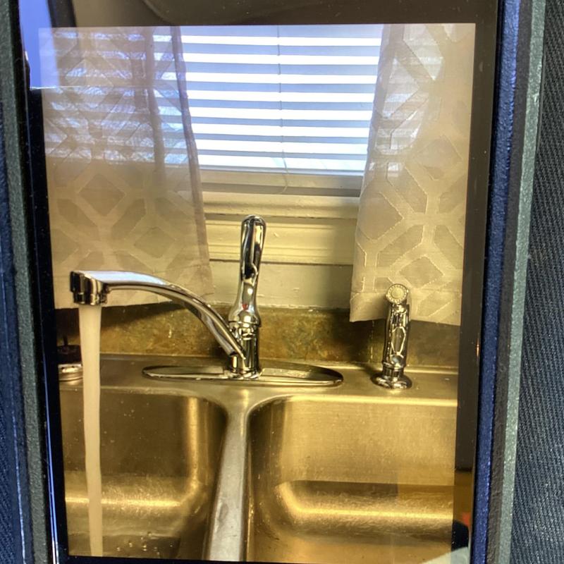 Kitchen faucet with running water over double sink