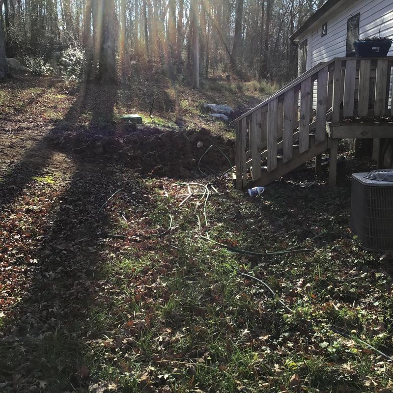 Plastic septic tank site with outdoor stairs and AC unit