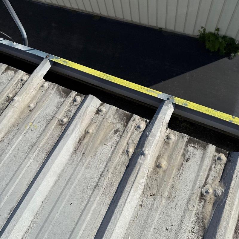 Metal roofing sheets with fasteners and edge trim