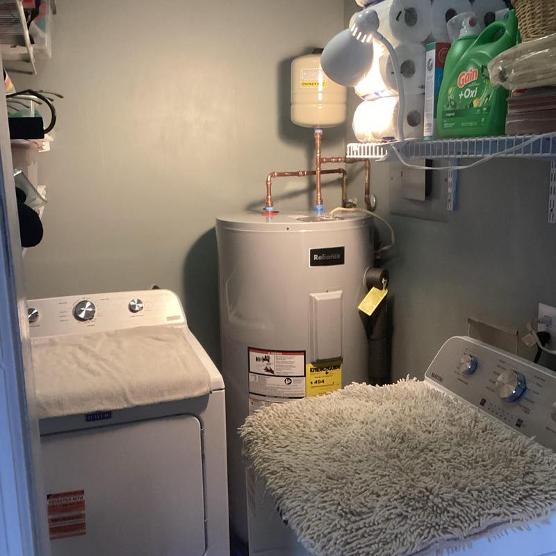 Water heater with attached expansion tank in laundry room