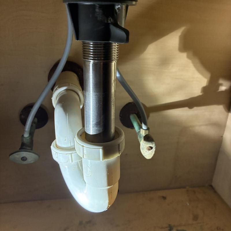 Lavatory popup drain assembly with PVC trap under sink