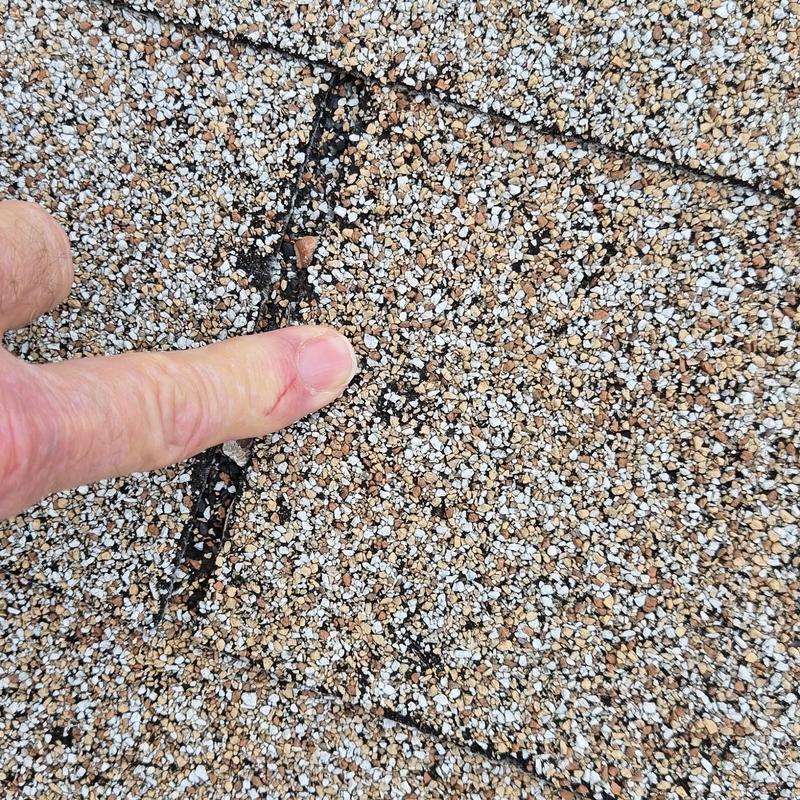 Asphalt shingle granule loss on roof during inspection