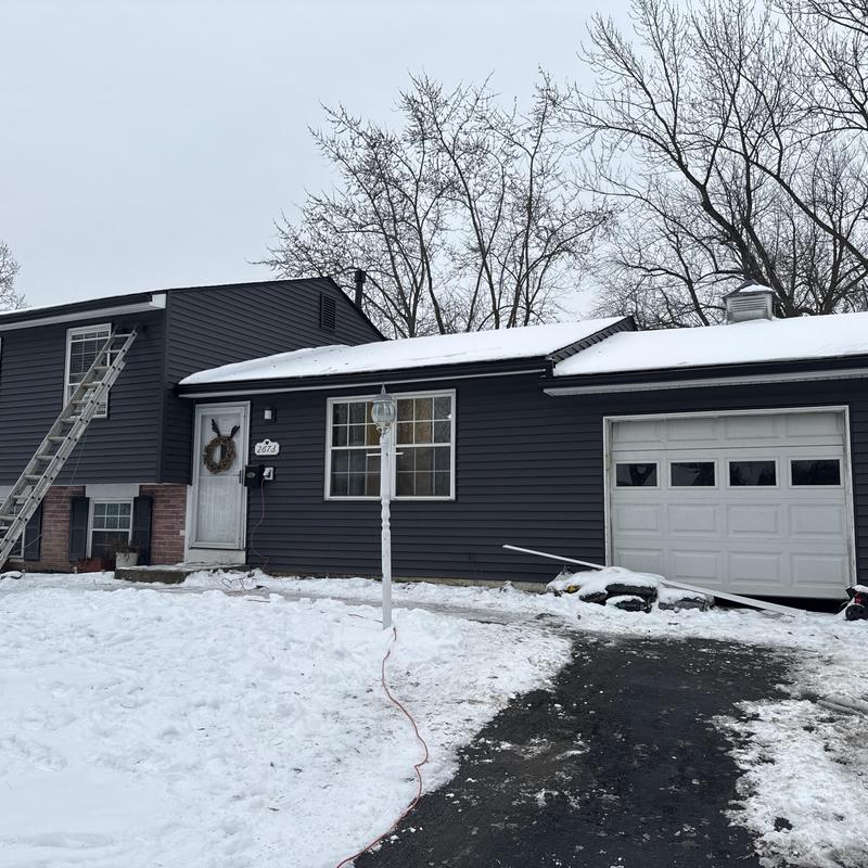Gutter and gutter guard installation on dark siding house Gutter and gutter guard installation on dark siding house
