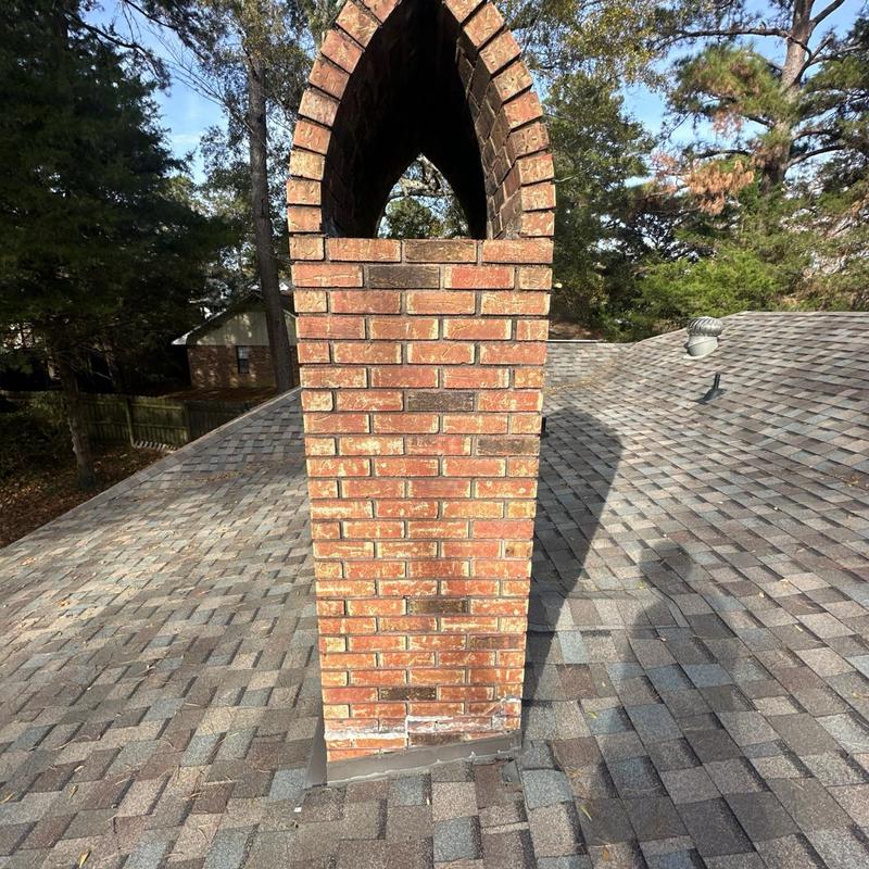 Brick chimney flashing on shingle roof inspection