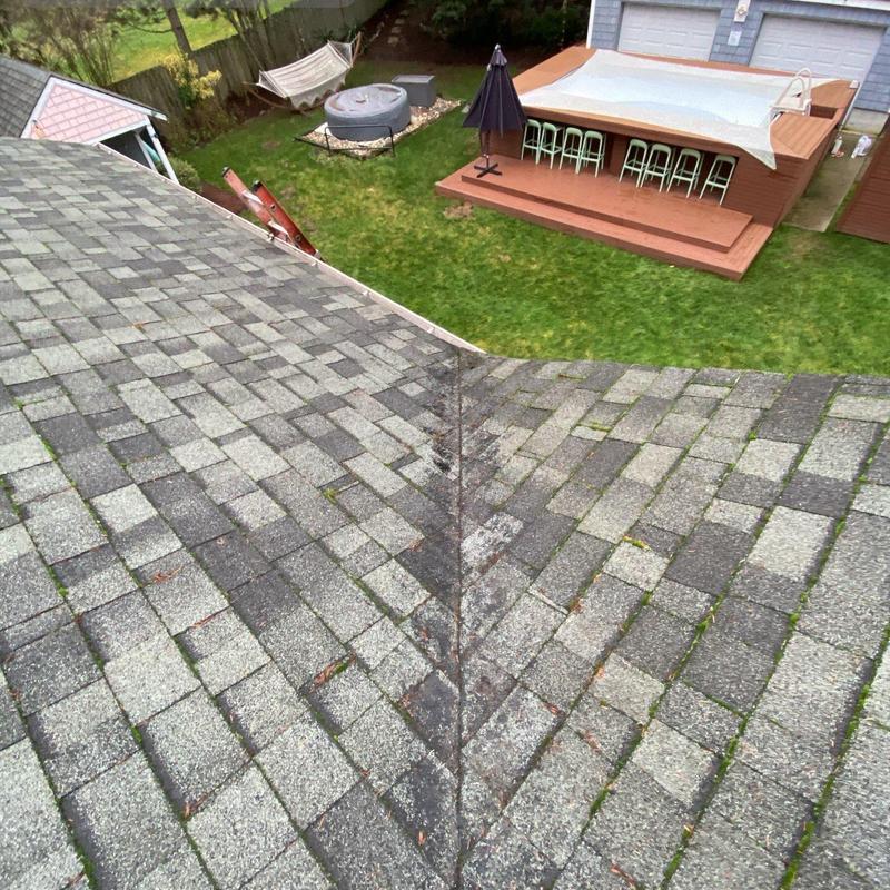Roof valley with asphalt shingles and outdoor deck view