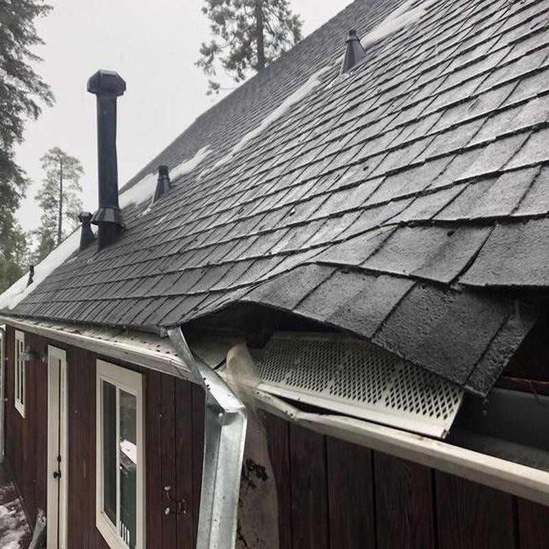 Asphalt shingle roof with damaged gutter and fascia