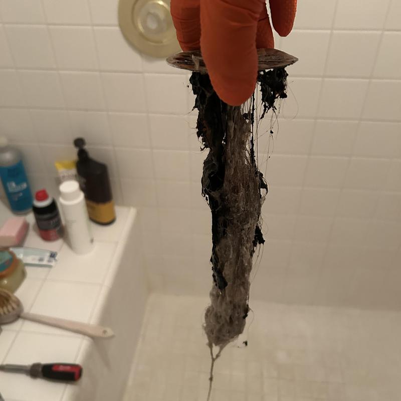 Shower drain hair clog removal with debris attached