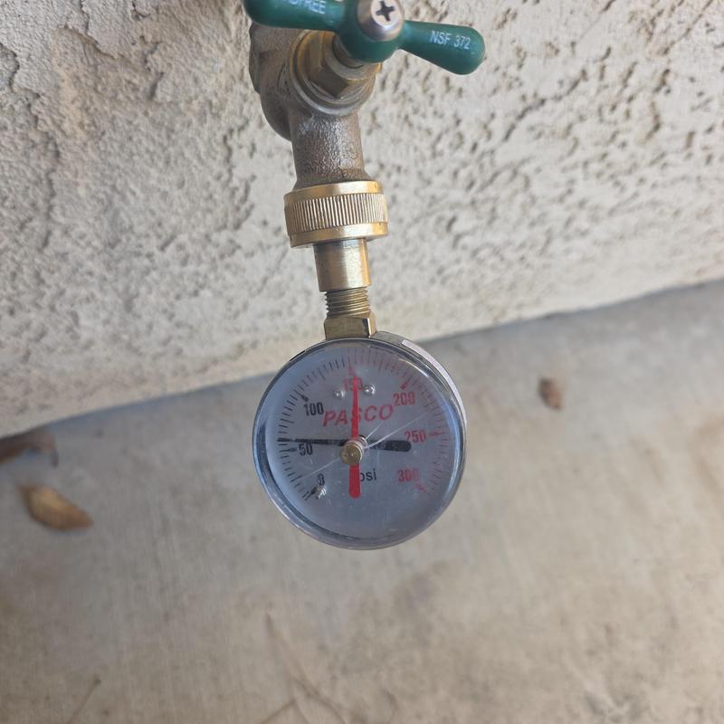 Outdoor water pressure gauge on garden faucet valve