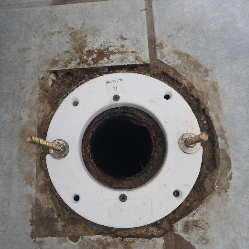 Toilet closet flange installed on tile floor without toilet