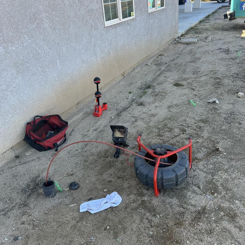 Sewer drain snake and camera inspection tools outside house