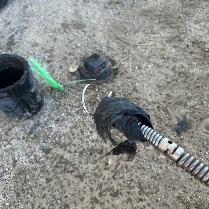 Sewer cleanout with clogged wipes on drain snake tool