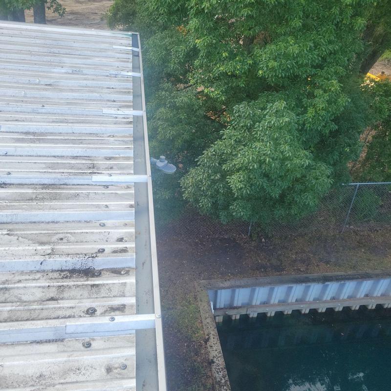 Gutters and metal roof after debris cleaning and repair Gutters and metal roof after debris cleaning and repair