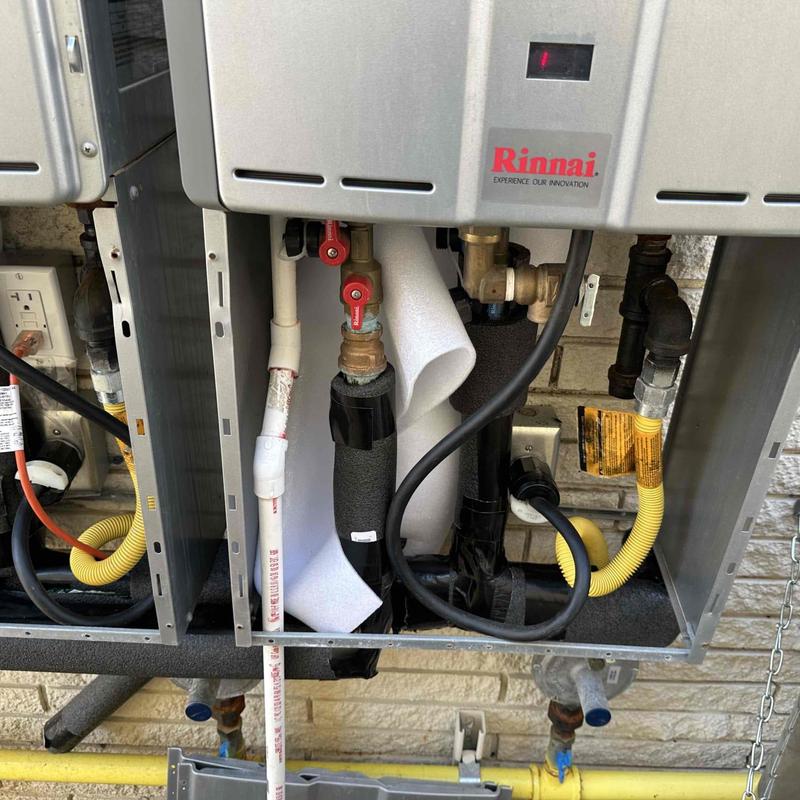 Water heater with insulation added to pipes