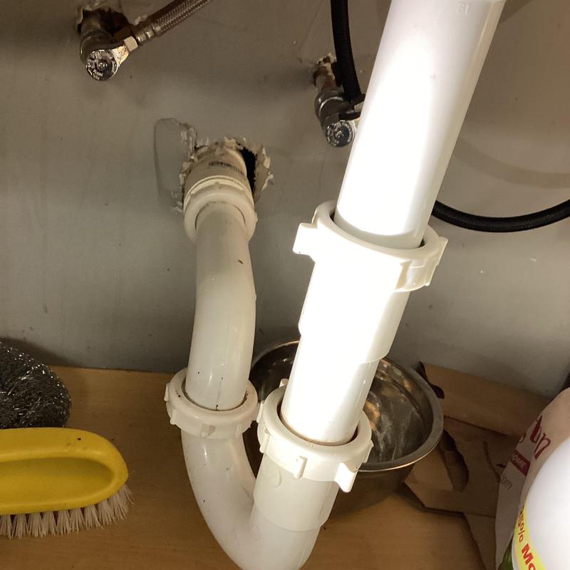 PVC drain pipe under kitchen sink with clean connections