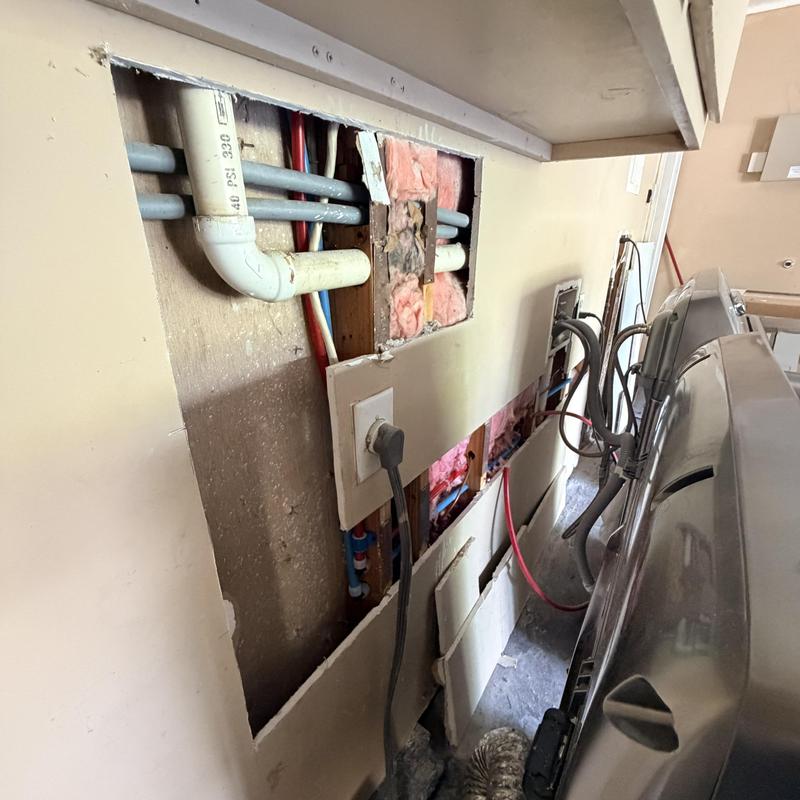 PEX piping installation behind laundry room wall
