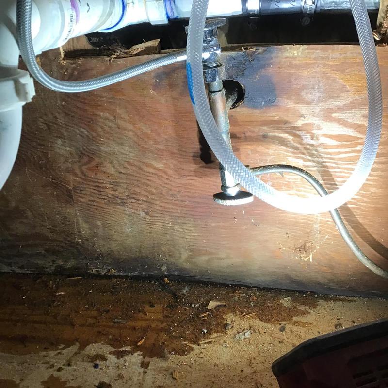 Horizontal water supply pipe behind cabinet removal area