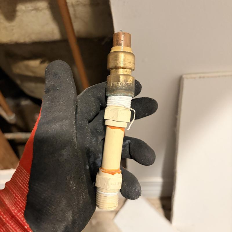 Uponor PEX-A pipe section with adapters in hand