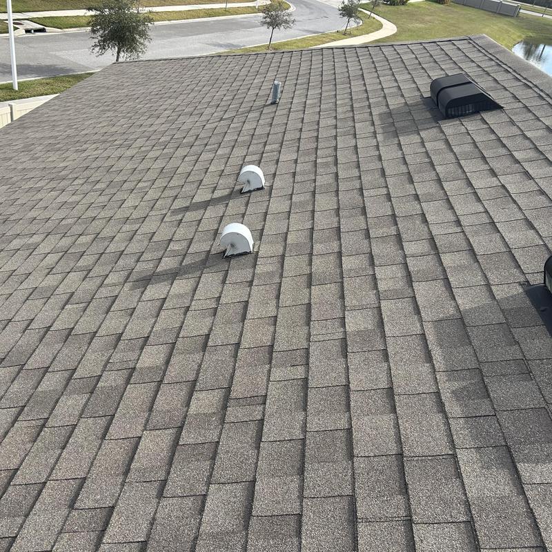 Shingle roof with pipe and vent flashings sealed