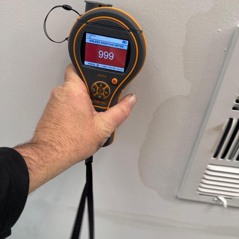 Moisture meter reading on ceiling near vent