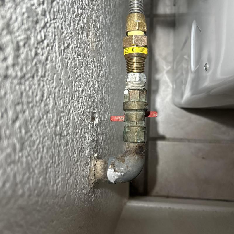 Dryer gas line with valve and fittings against wall