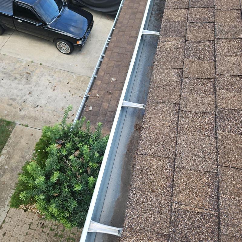 Gutter with new straps and cleaned debris Gutter with new straps and cleaned debris