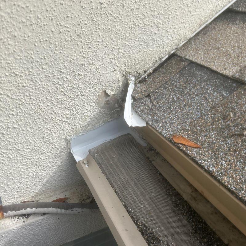 Metal diverter at gutter and roof edge installation Metal diverter at gutter and roof edge installation