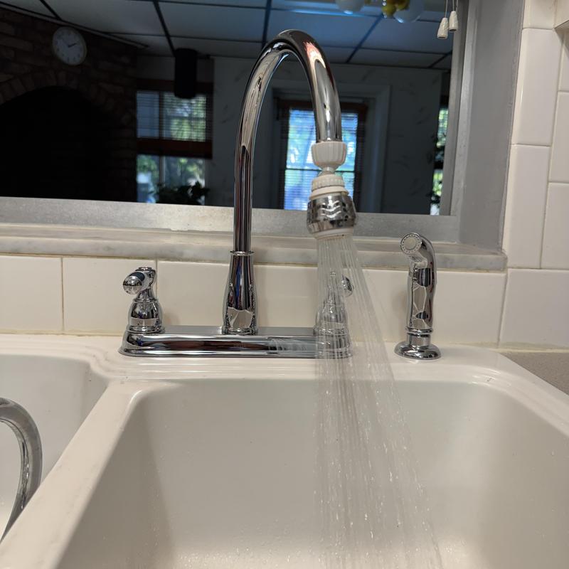 Delta kitchen faucet with side sprayer running water in sink