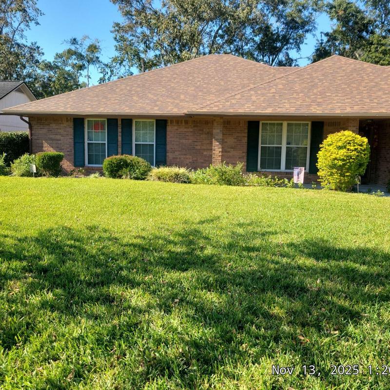Asphalt shingle roof on residential house in sunlight Asphalt shingle roof on residential house in sunlight