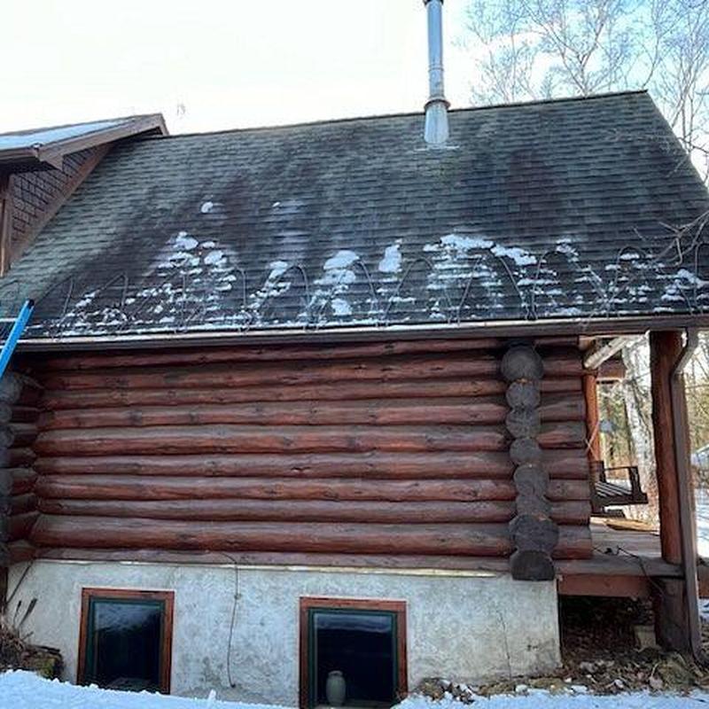 Heat cable system on log cabin roof in winter Heat cable system on log cabin roof in winter