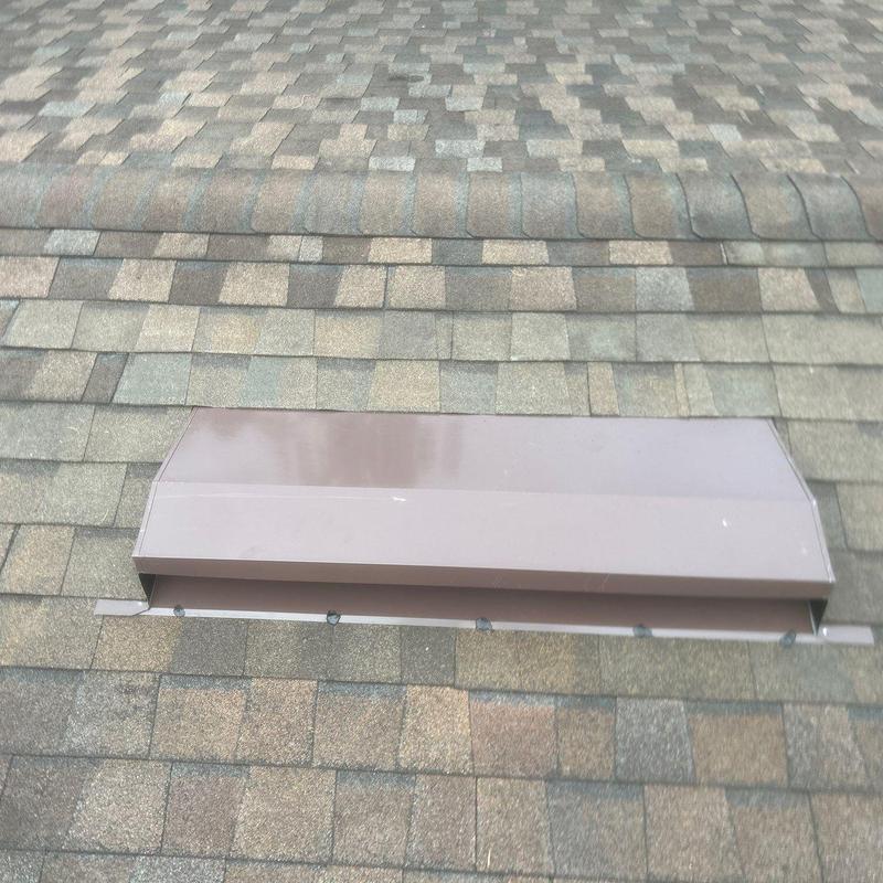 Ridge vent section installed on asphalt shingle roof Ridge vent section installed on asphalt shingle roof