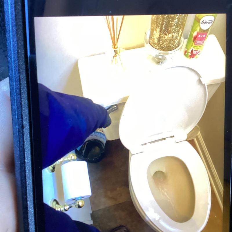 Toilet flushing test with open lid in bathroom