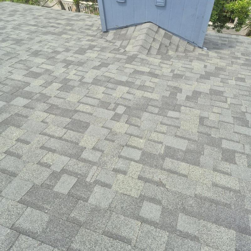 Asphalt shingle roof with chimney base flashing Asphalt shingle roof with chimney base flashing