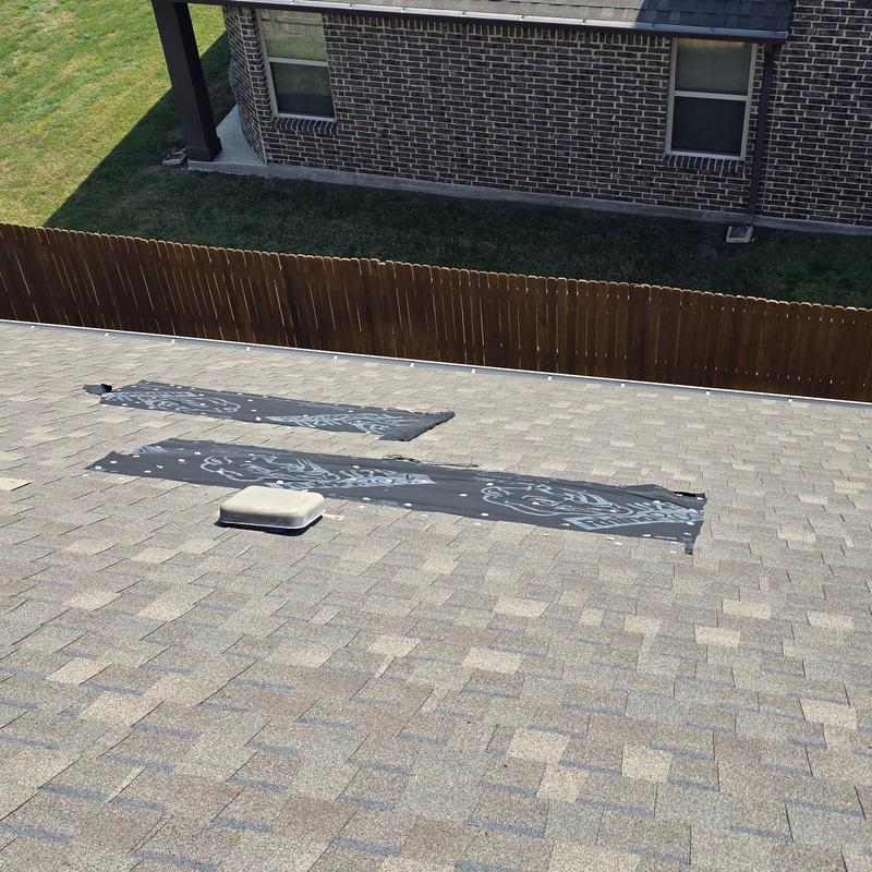 Asphalt shingle roof with hail damage and protective wrap Asphalt shingle roof with hail damage and protective wrap