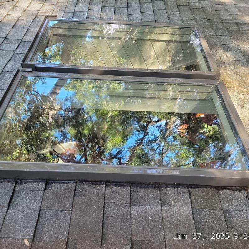 Skylight glass and frame on shingled roof Skylight glass and frame on shingled roof