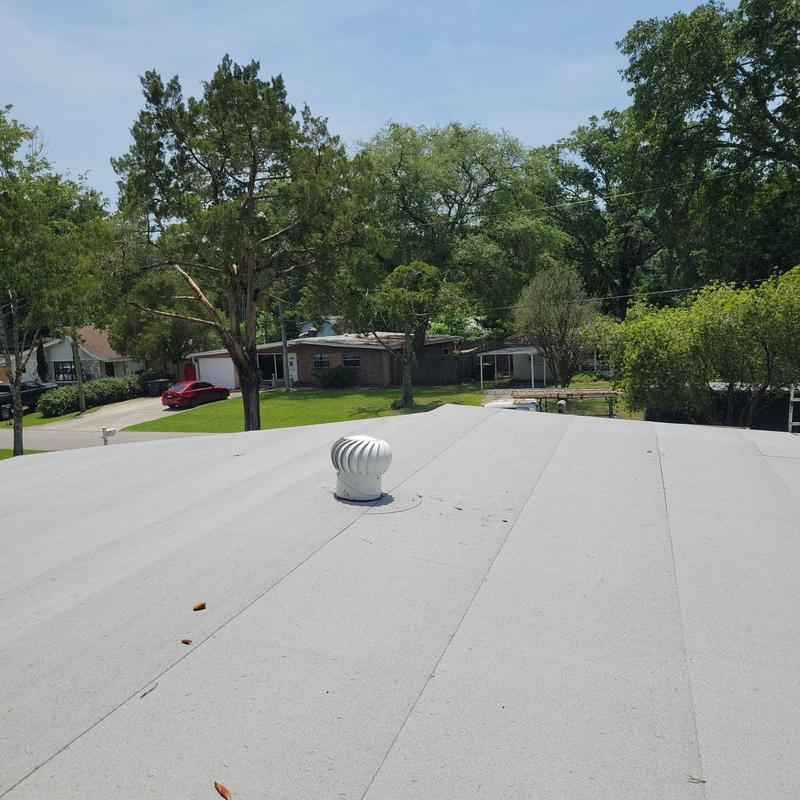 Flat roof with turbine vent installed in residential area Flat roof with turbine vent installed in residential area