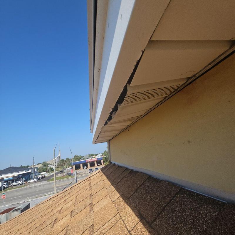 Soffit and fascia with visible damage on roof edge Soffit and fascia with visible damage on roof edge