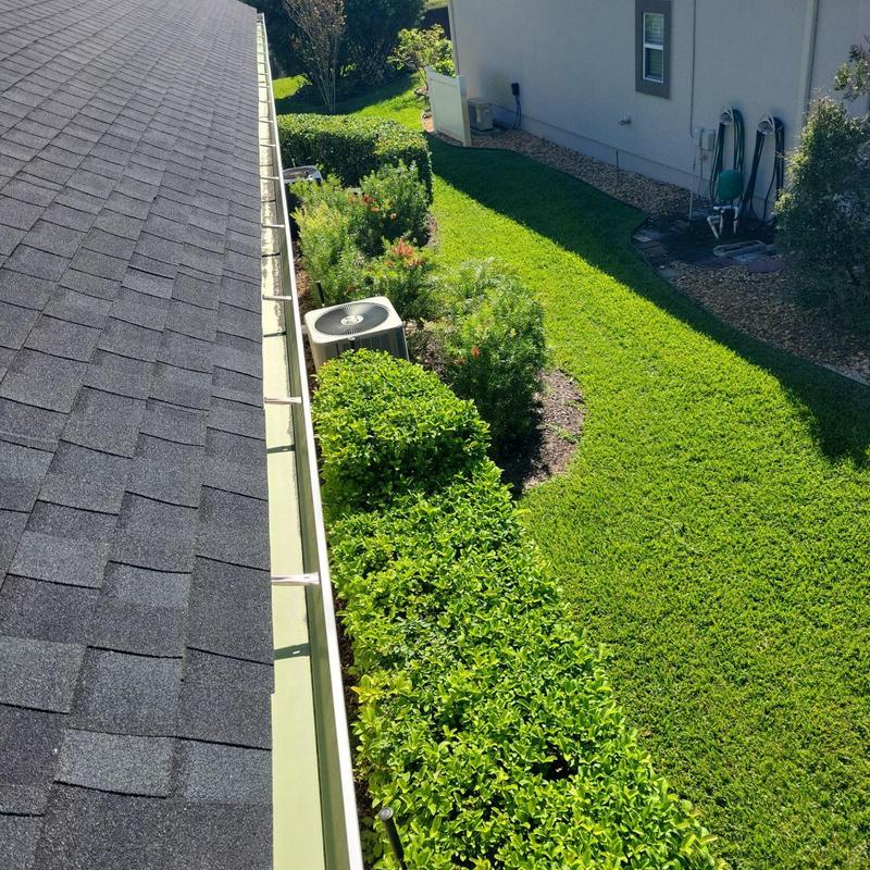 Gutter system cleaned of debris on residential roof Gutter system cleaned of debris on residential roof
