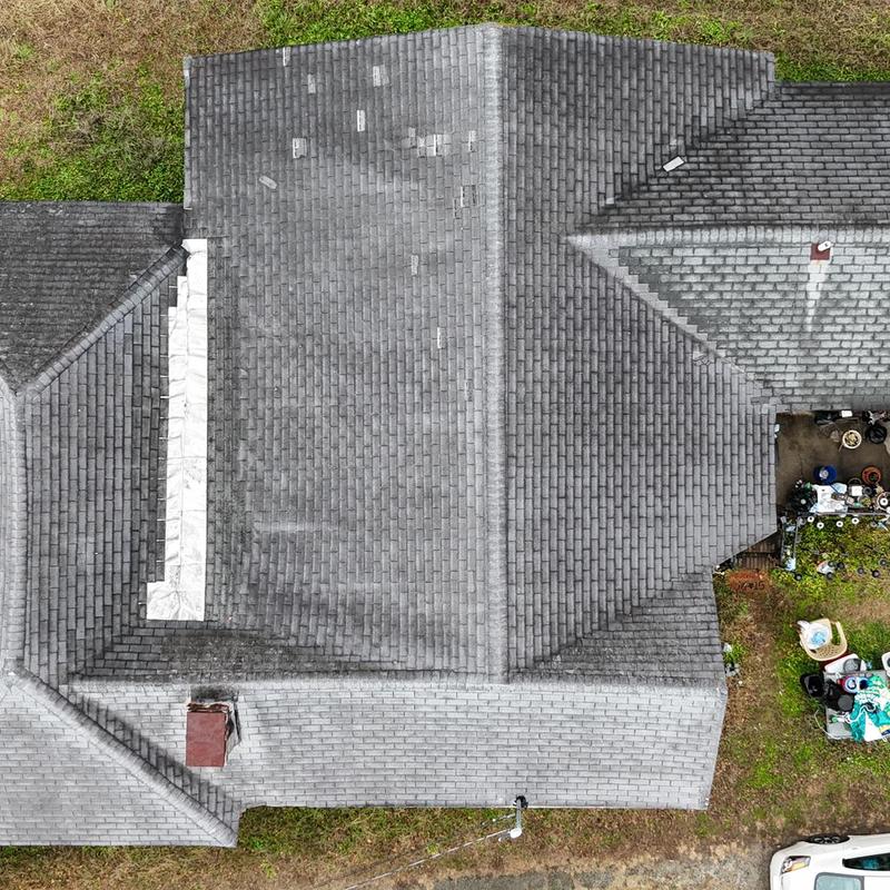 Asphalt shingle roof with weathering and damage areas