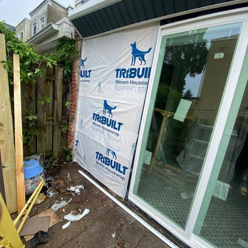 Woven housewrap installation by sliding glass door