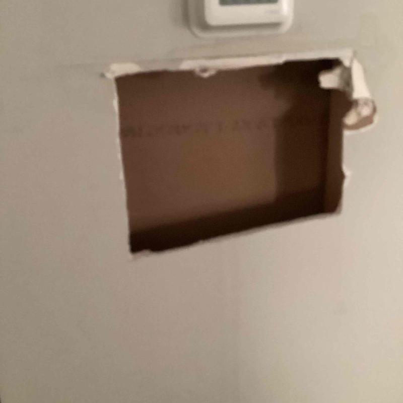 Drywall cutout in interior wall with no pipes visible