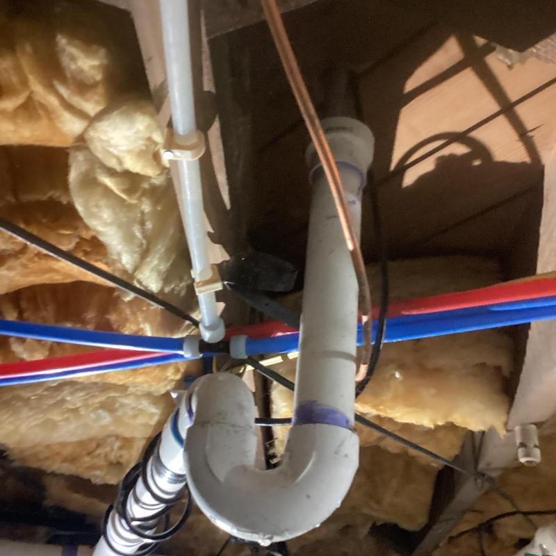 Ice maker drain pipe with plumbing and insulation