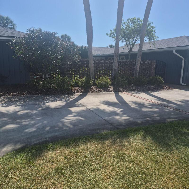 Roof shingles on house with brick privacy wall Roof shingles on house with brick privacy wall